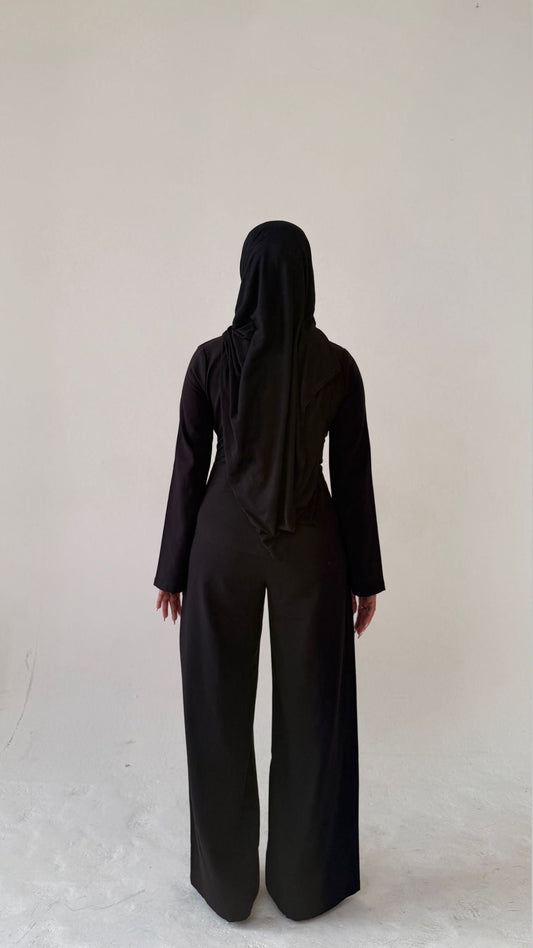 Model facing away showing back view of Muse tailored top in noir black, designed for petite frames with structured fit
