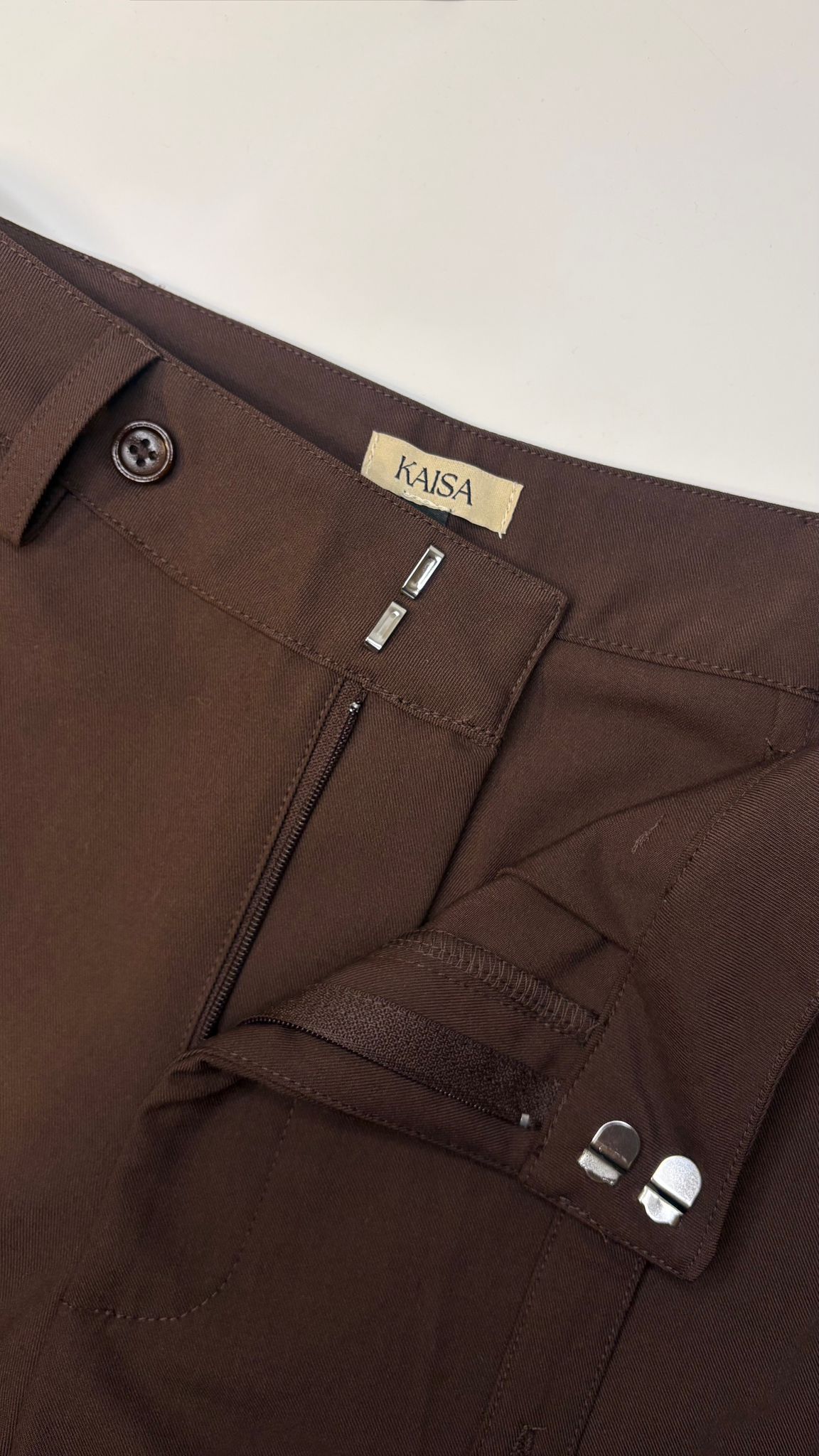 Close-up of Muse straight leg trousers in coffee brown showing open fly zipper detail, tailored fit for petite frames