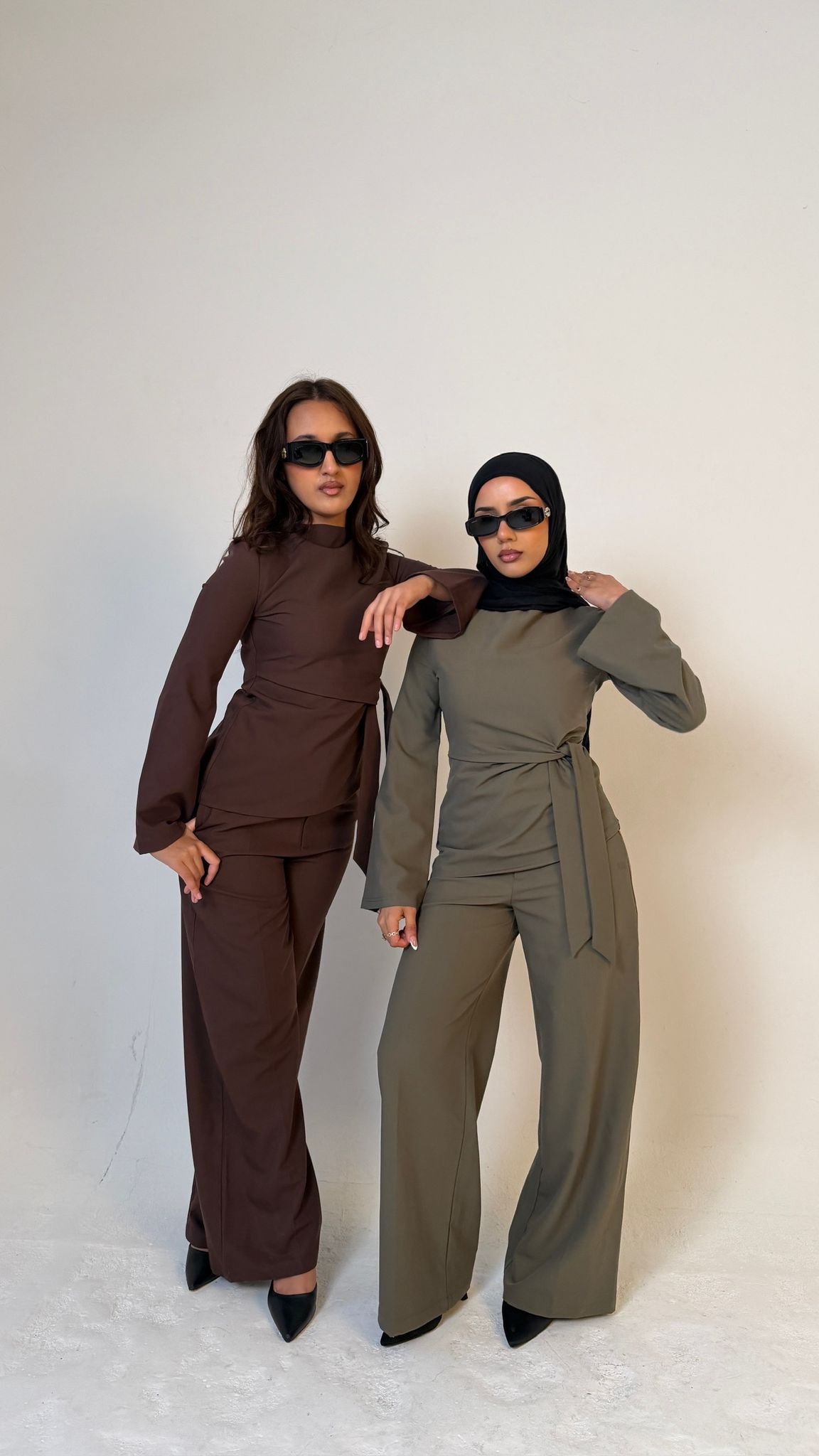 Two models facing forward wearing Muse straight leg trousers in olive green and the other model is in coffee brown, tailored fit for petite frames