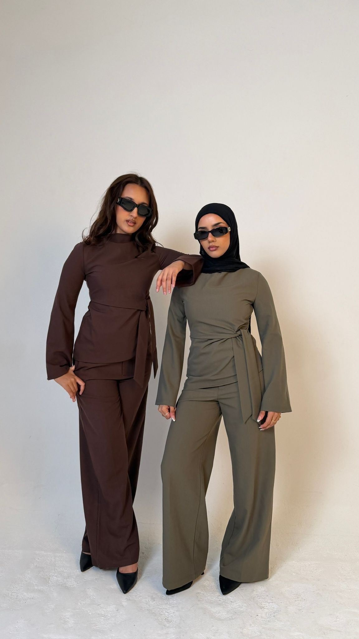 Two models posing in Muse straight leg trousers in olive green & coffee brown, tailored fit for petite frames