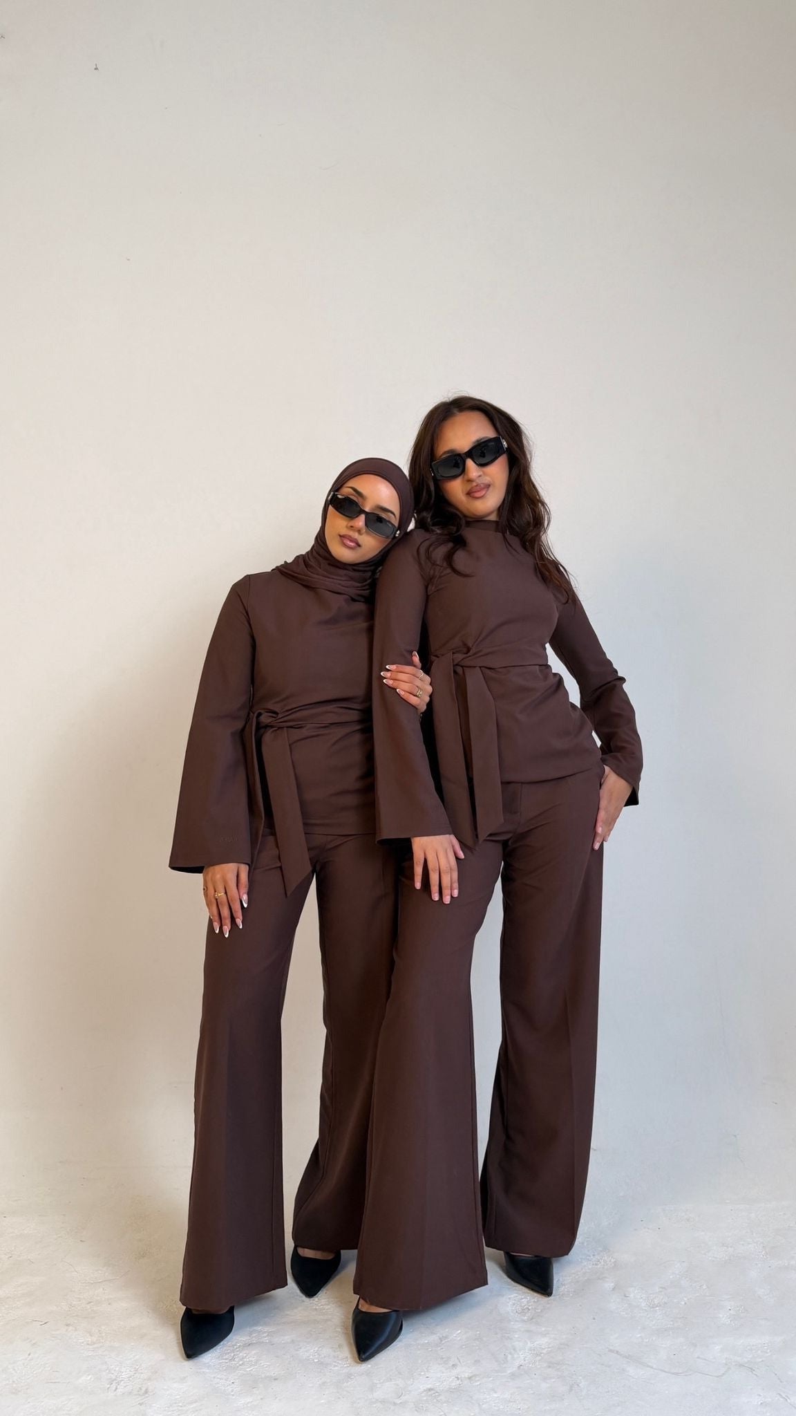 Two models facing forward wearing Muse tailored tops in coffee brown, designed for petite frames with structured fit