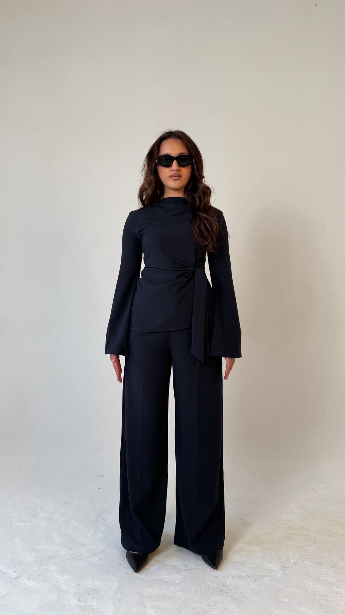 Model facing forward wearing Muse tailored top in midnight blue, designed for petite frames with structured fit