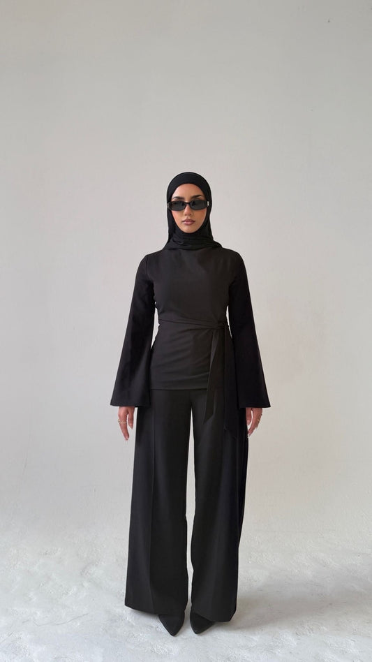 Model facing forward wearing Muse tailored top in noir black, designed for petite frames with structured fit