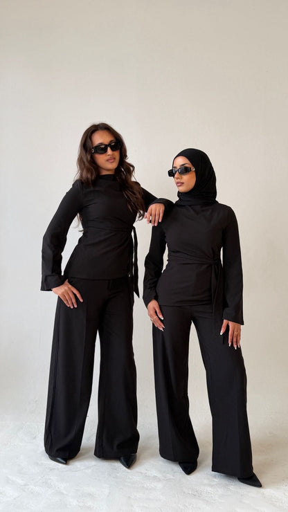 Two models facing forward wearing Muse tailored tops in noir black, designed for petite frames with structured fit