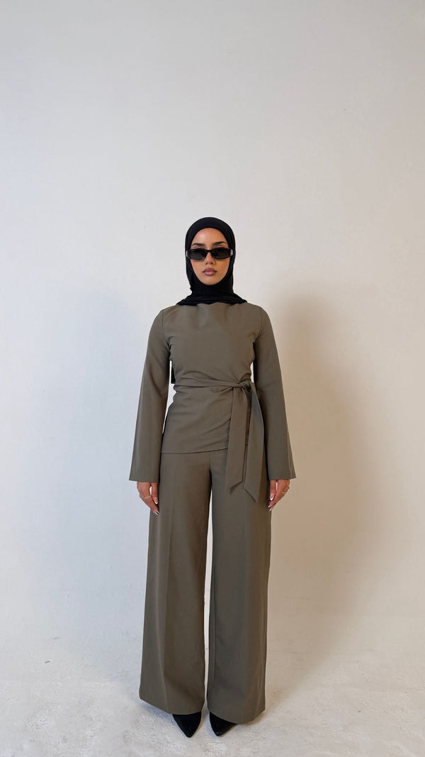 Model facing forward wearing Muse tailored top in olive green, designed for petite frames with structured fit
